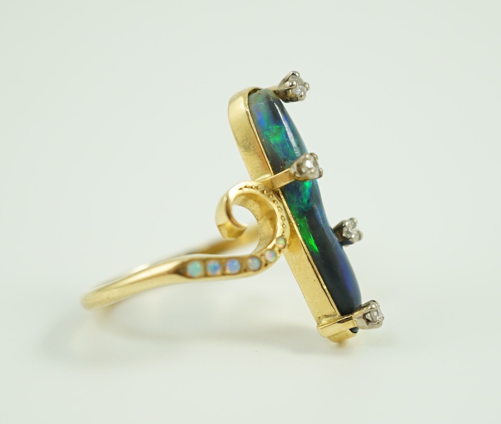 A stylish early to mid 20th century 18ct gold, black opal and diamond chip set dress ring